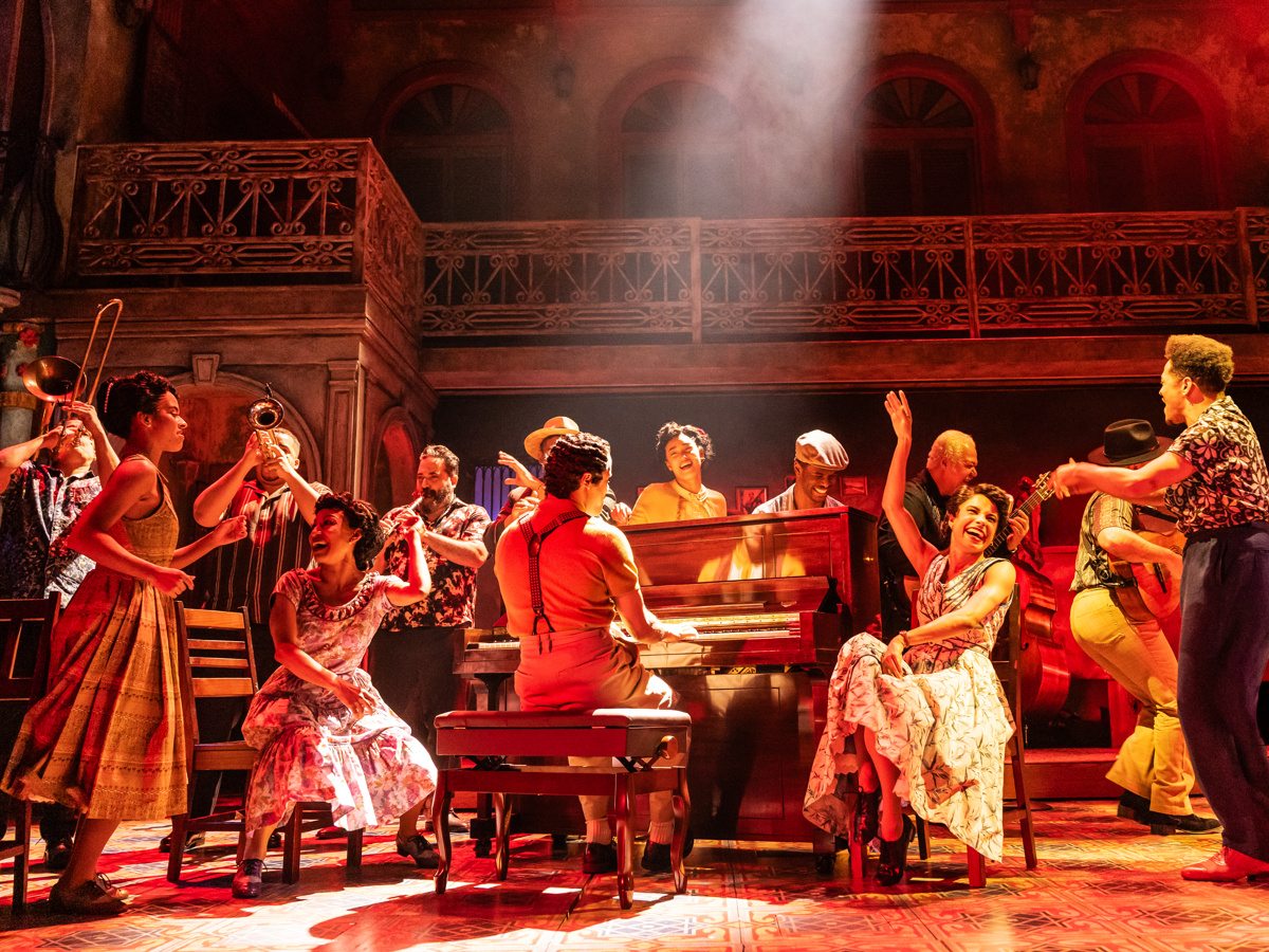 people gather around the piano happily